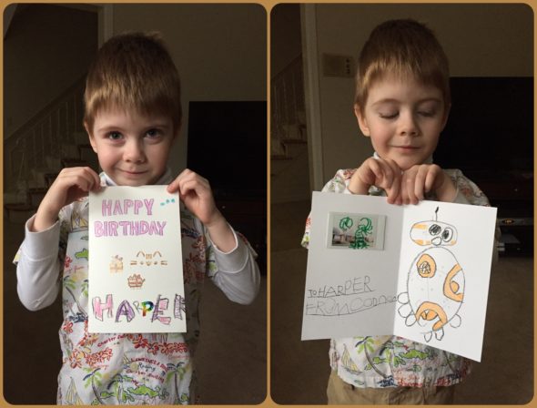 Connor holding his homemade card