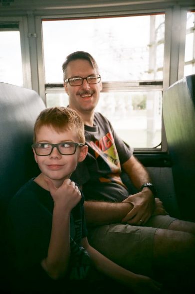 Dad and Connor on the shuttle bus for the Black Swamp Arts Festival