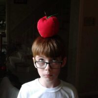 Connor with an apple plushie on his head